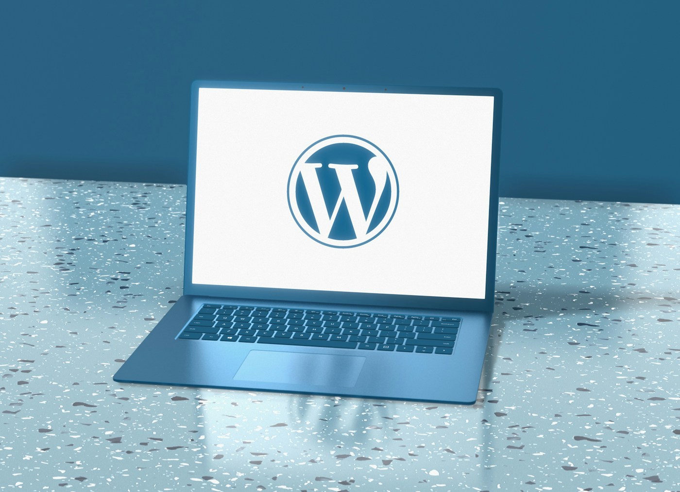 Laptop and WordPress-themed workspace representing the HICONY Article Bridge content workflow